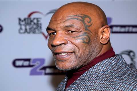 Mike Tyson laughs down phone in airport lounge just minutes after beating a fan on plane