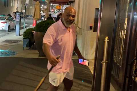 Fearsome Mike Tyson, 56, pictured using walking stick as former heavyweight champion arrives at New ..