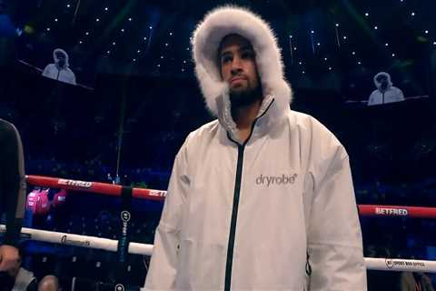 Itauma wraps up in hooded jacket during ring walk on Tyson Fury vs Derek Chisora undercard to..