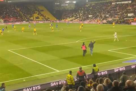 Shocking moment Watford fan lashes out at steward after he storms pitch to confront players