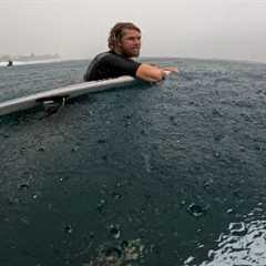 SURFING IN A RAIN STORM AT PIPELINE