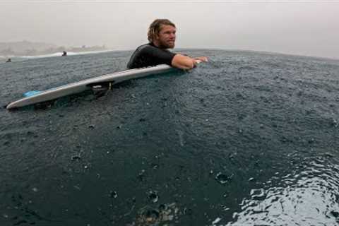 SURFING IN A RAIN STORM AT PIPELINE